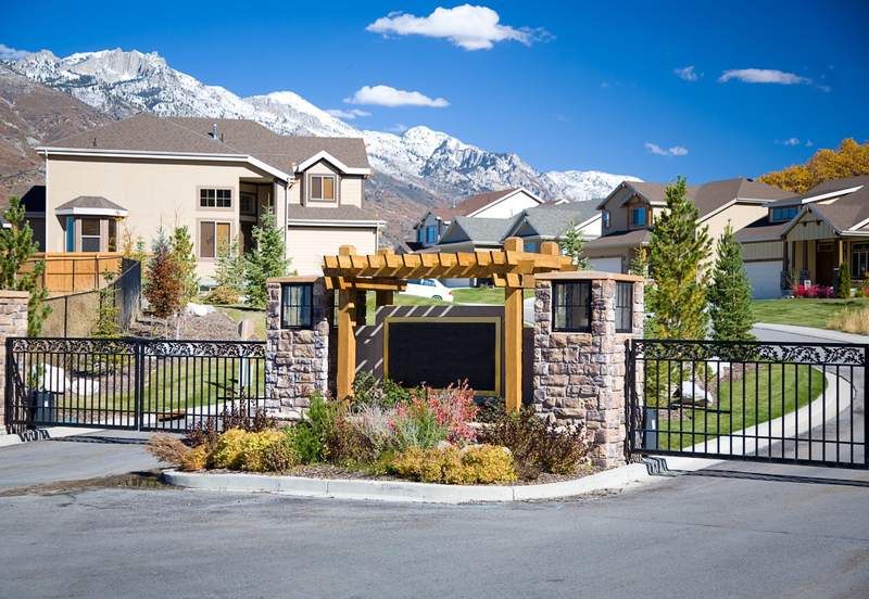 View of the entrance to a gated community of homes.